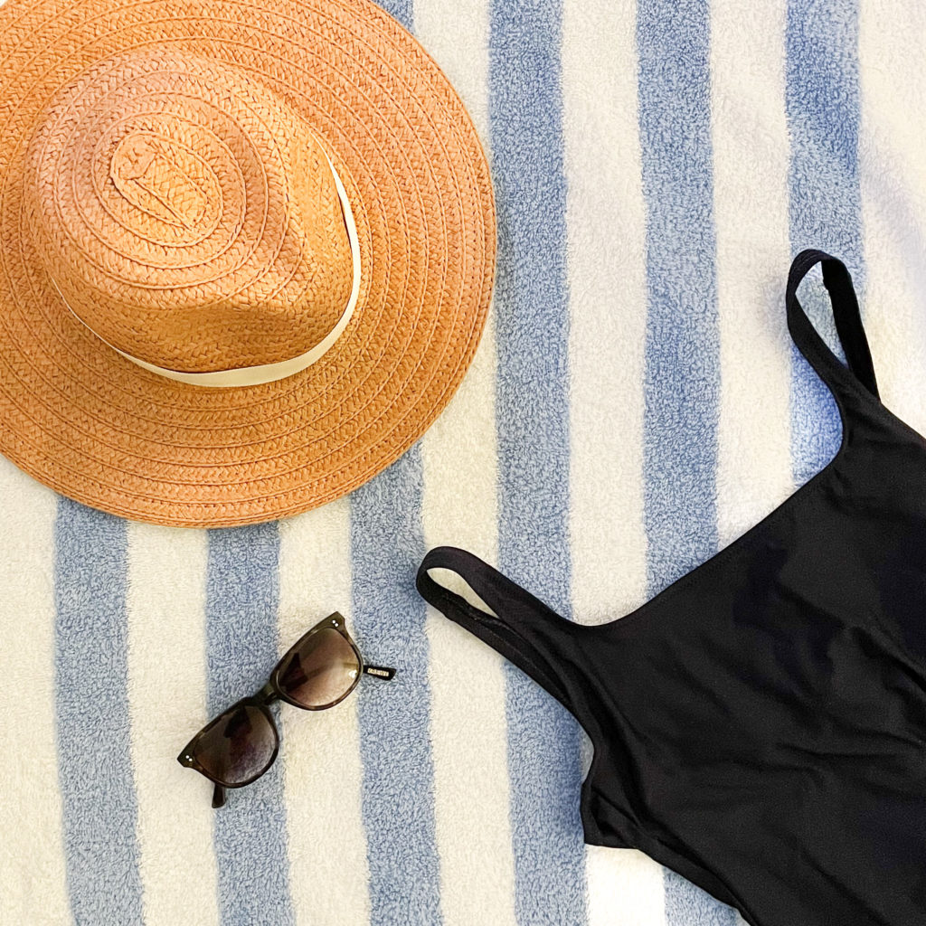 J Crew swimsuit with madewell hat and sunglasses